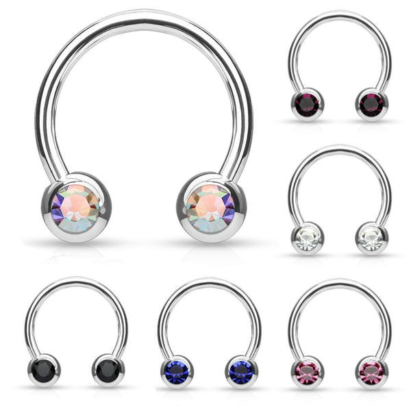 A steel horseshoe style ring with gem balls on both ends. Shown in aurora borealis gems, purple gems, clear gems, black gems, blue gems, and pink gems.